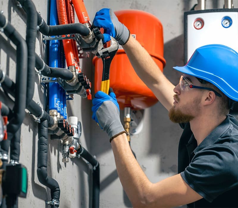 Professional plumber working on modern sink installation