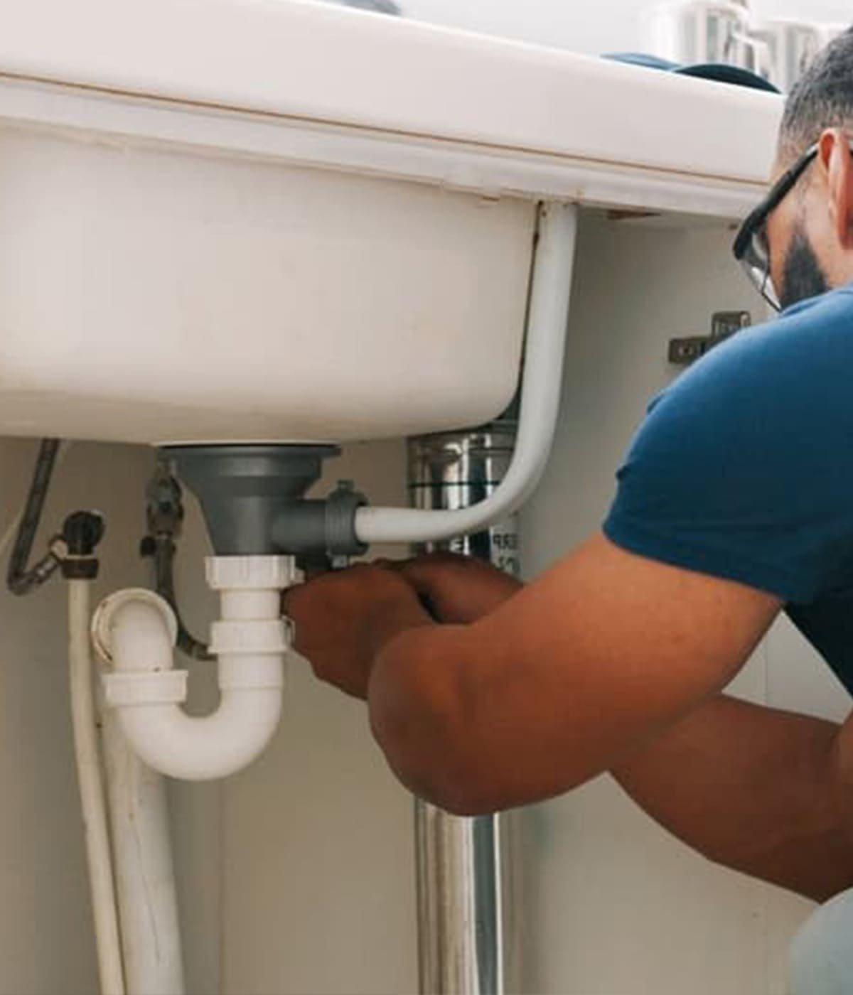 Professional plumber repairing pipes